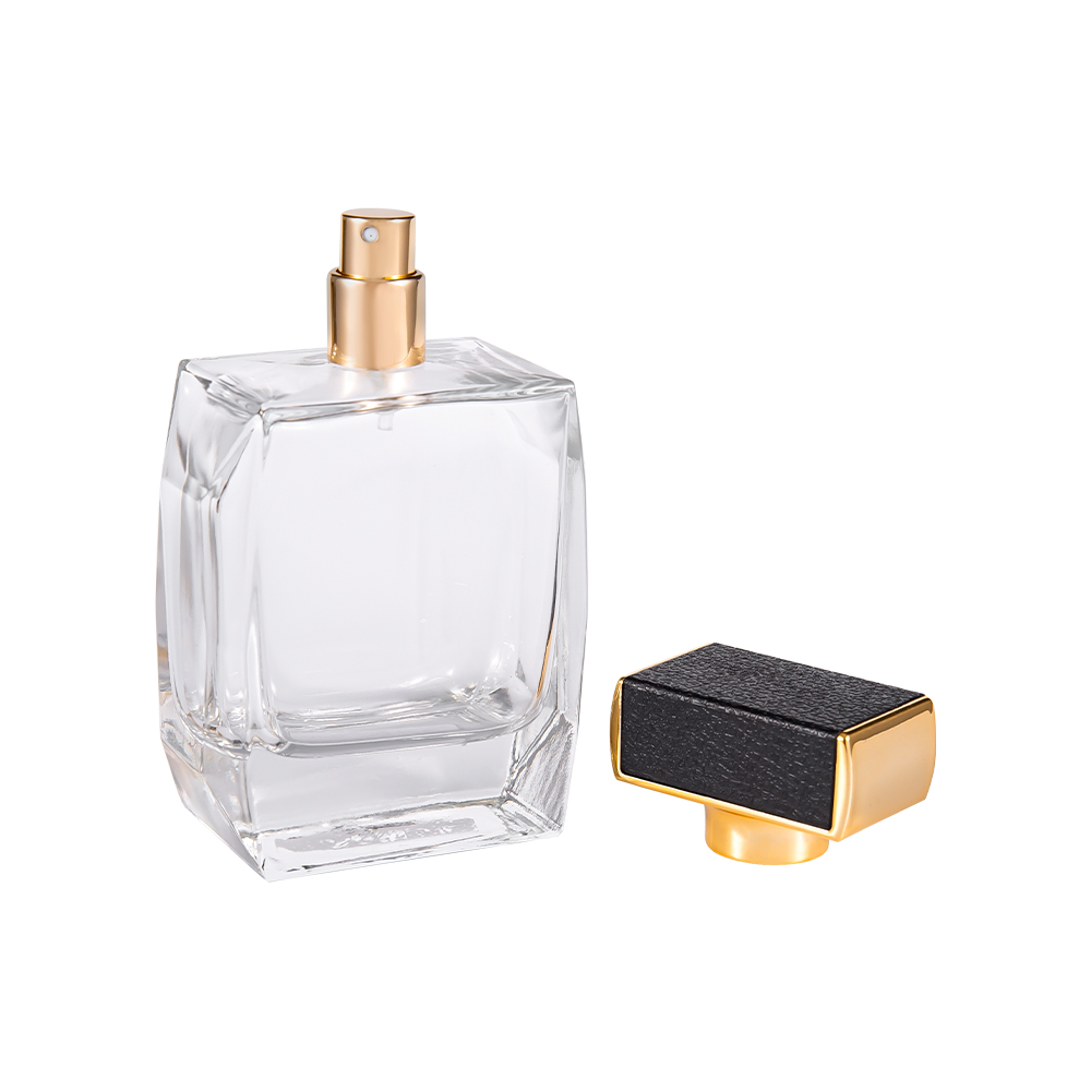 KY1092-WJ2092 Botella de perfume de vidrio transparente de 100 ml con cubierta de plástico de cuero y piezas bañadas en oro UV
