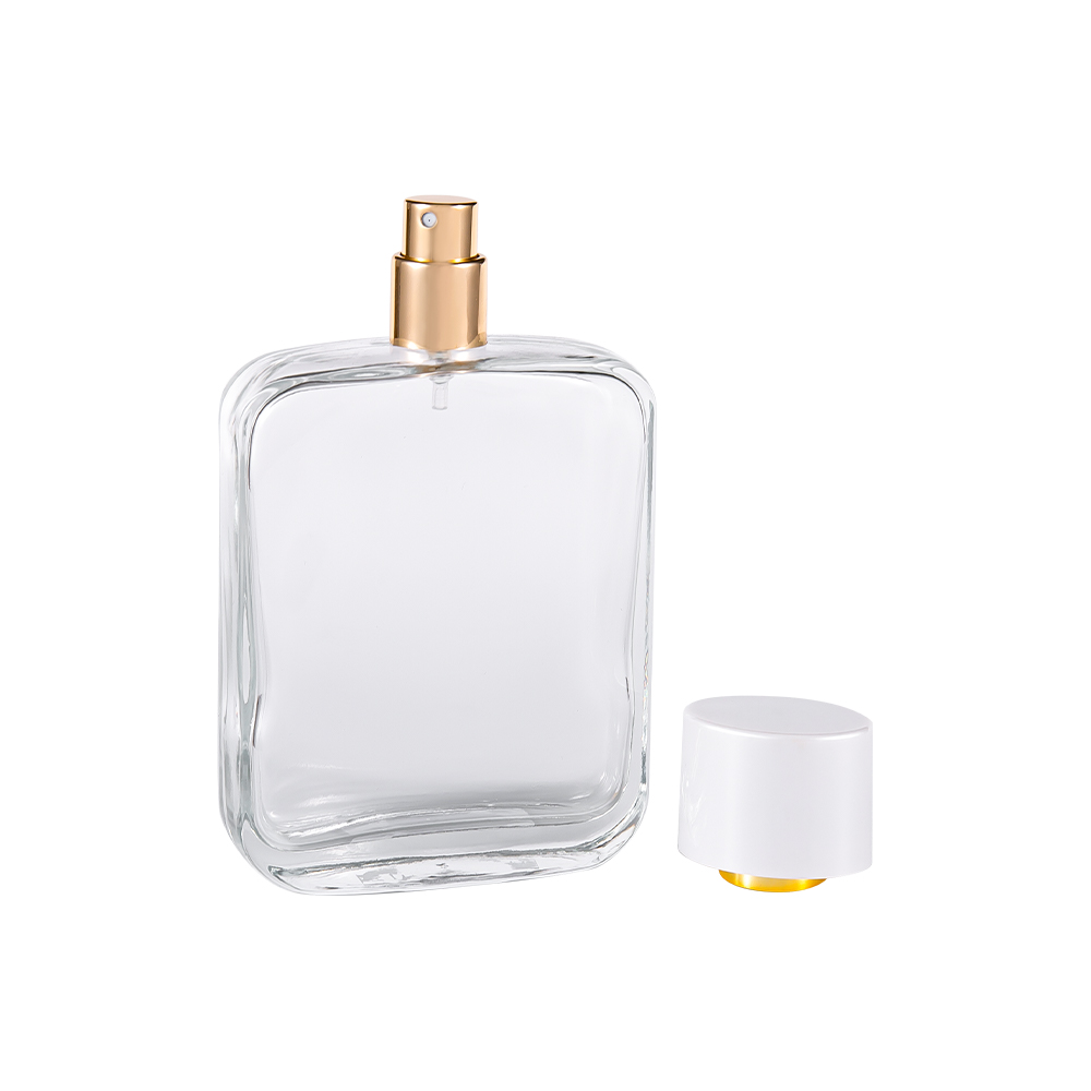 Botella de perfume de vidrio transparente GC4840-WJ2162 de 100 ml con tapa de plástico Pp blanco brillante y revestimiento chapado en oro UV